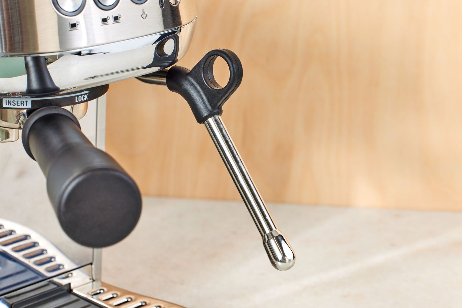 Closeup of Breville Bambino Plus Espresso Machine handle and steamer wand