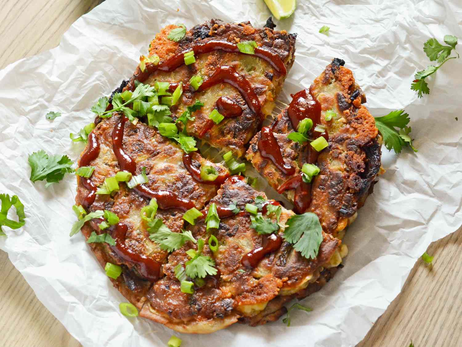 Overhead view of a crispy bulgogi scallion pancake cut into quarters