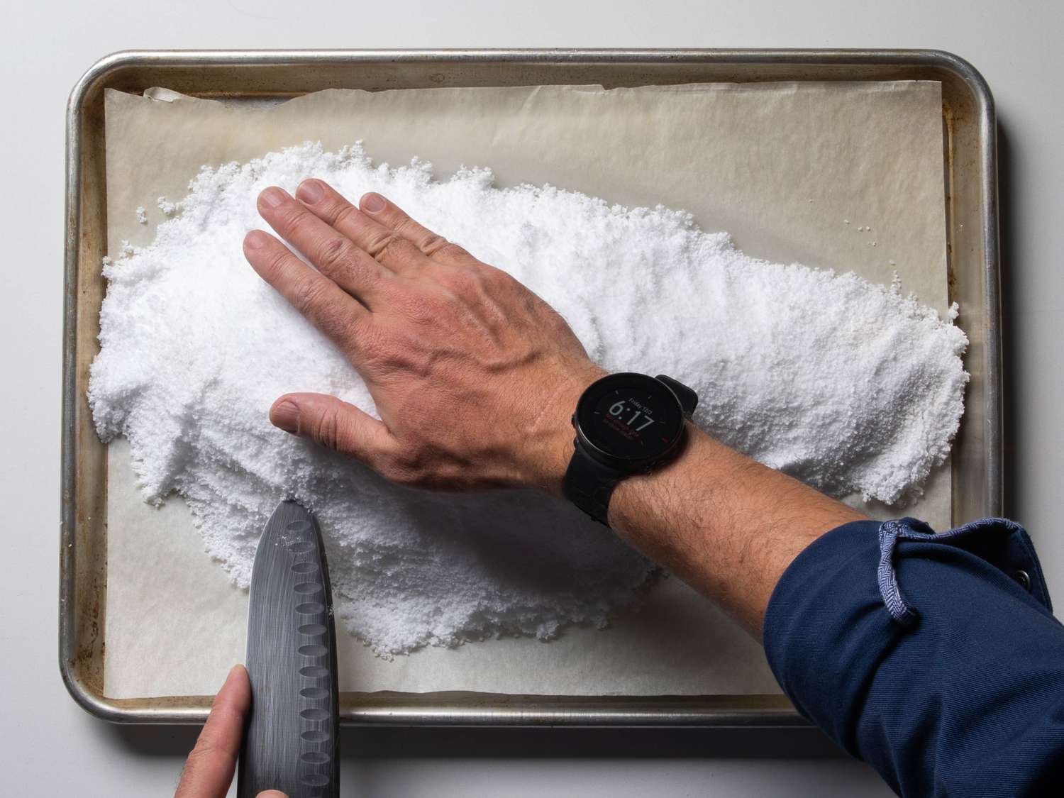 Use a knife to slice open the salt crust from the side. It can then be lifted off in large pieces.