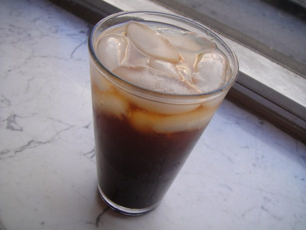 A glass of natural cola with ice. 