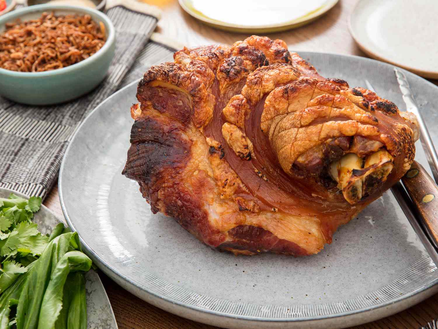 A Thai-inspired slow-roasted pork shoulder served on a gray platter.