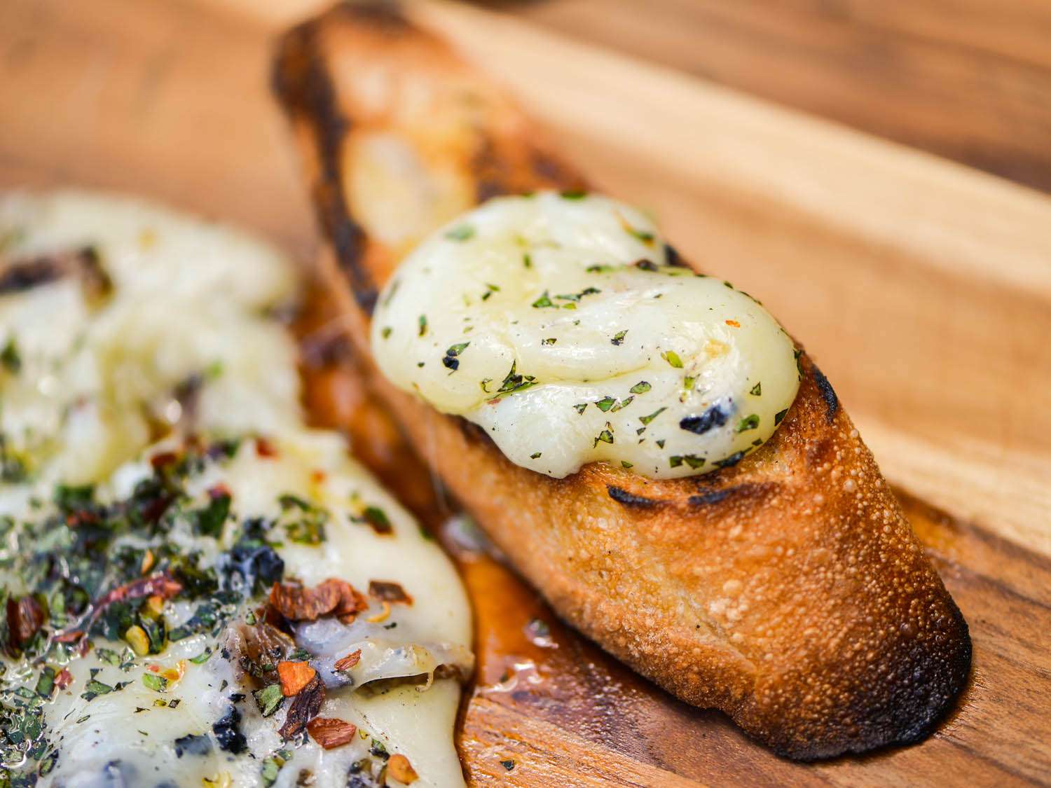 melted grilled provolone on crostini, finished with a drizzle of olive oil, chopped fresh oregano, and crushed red pepper