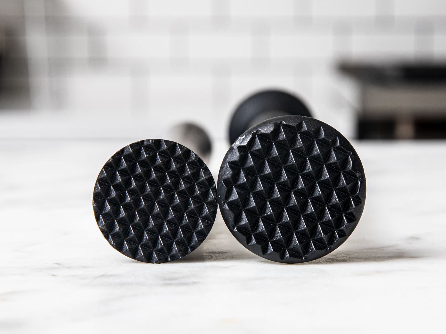 A front-on look at two textured muddler heads