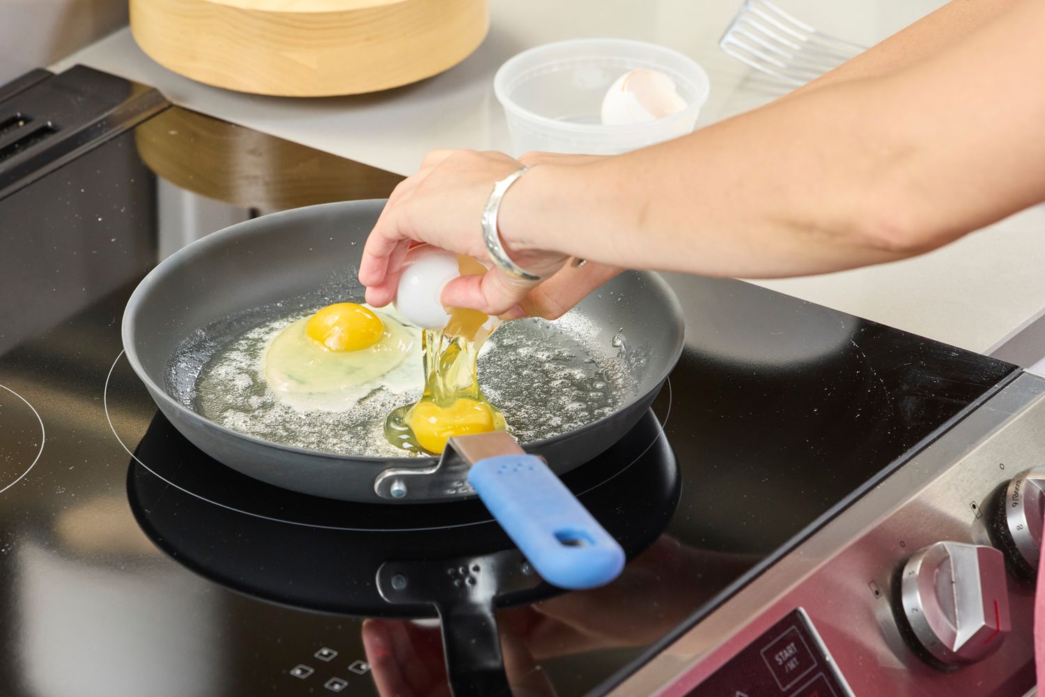 Eggs are cracked into the Misen Pre-Seasoned 10 Inch Carbon Steel Pan