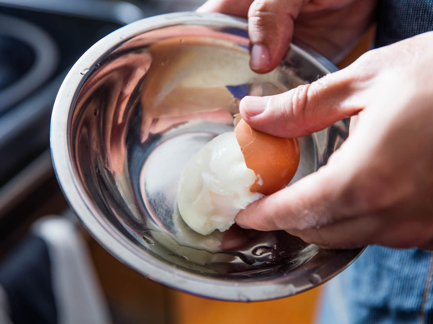 Author slips onsen egg out of its shell and into a small mixing bowl.