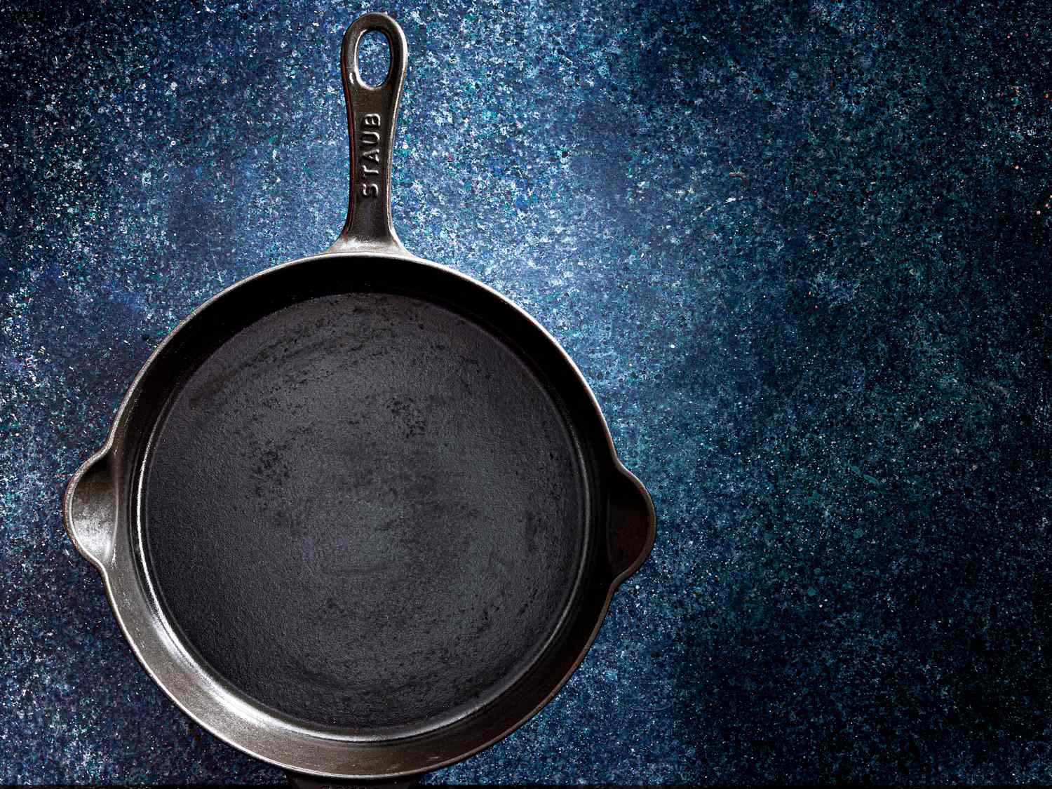 Cast Iron Pan on a blue back drop