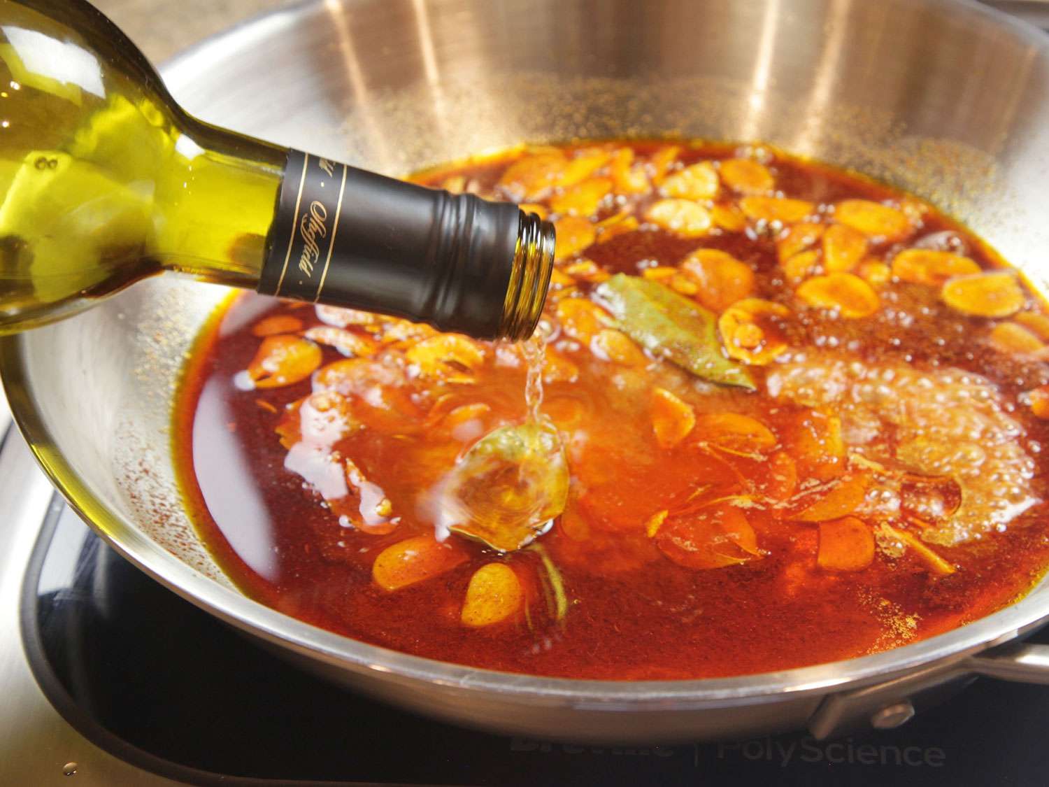 Sherry is added to the oil-garlic-pimentón mixture.