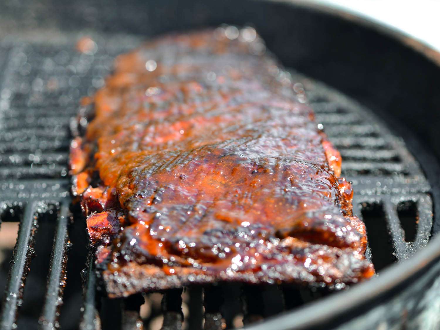 A rack of caramelized apricot-glazed pork ribs on the grill