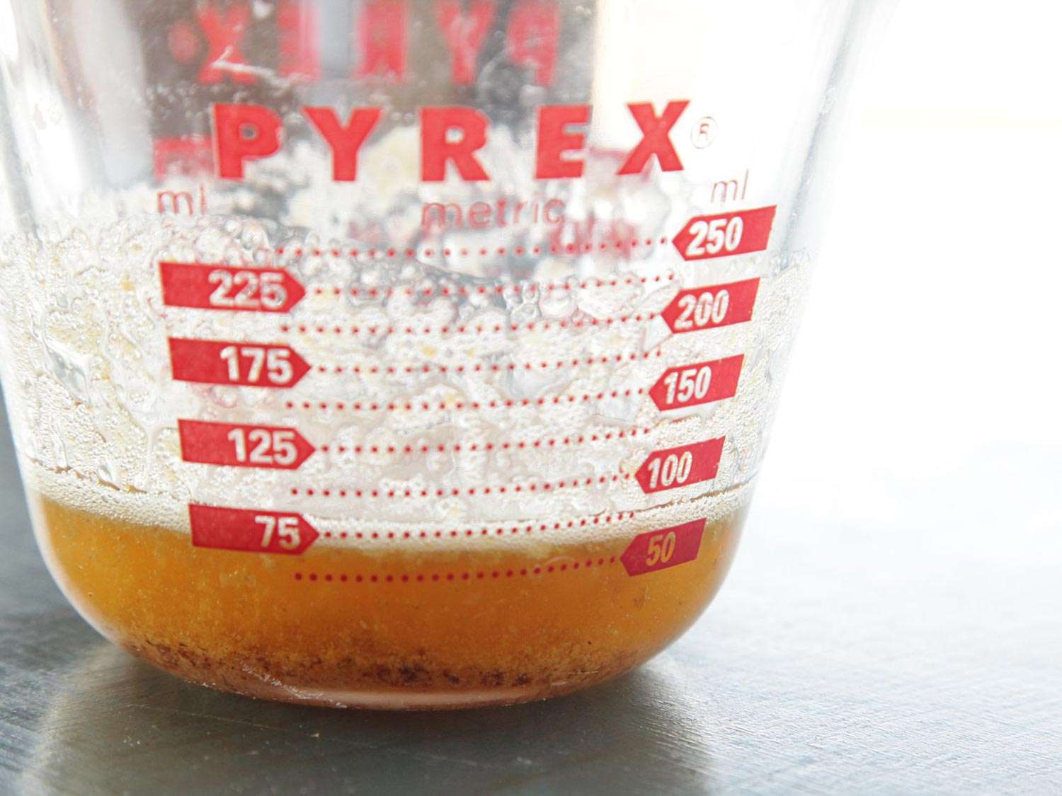 A glass Pyrex measuring cup with browned butter.