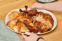 A cut up Omaha Steaks Whole Basted Turkey on a serving platter