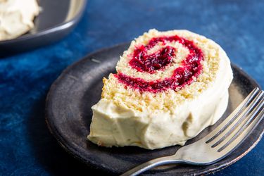 Jelly roll on a plate with a fork.