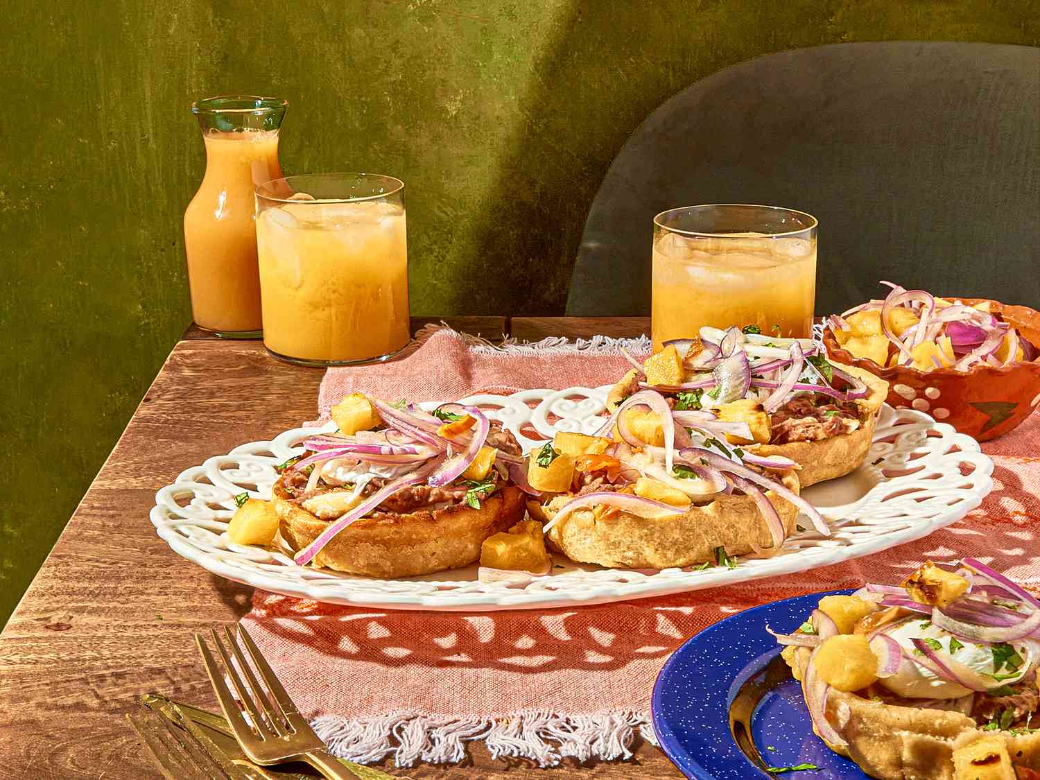 A white plqatter of breakfast sopes, served with agua fresca.