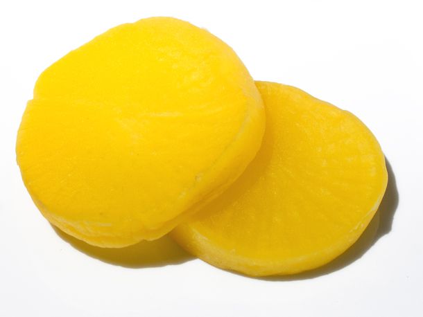 Round slices of bright yellow Japanese pickled daikon.