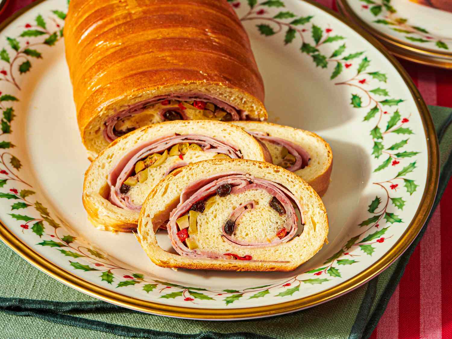 Pan de jamn on a decorative plate with slices showing the filling