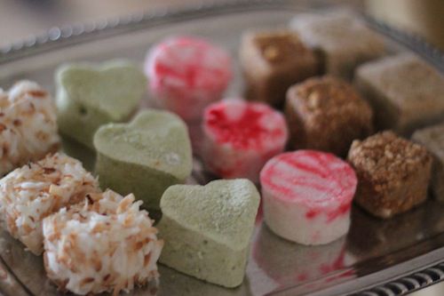 Assorted flavored marshmallows, arranged in rows of three on a silver platter.