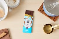 A milk chocolate bar on a kitchen countertop.