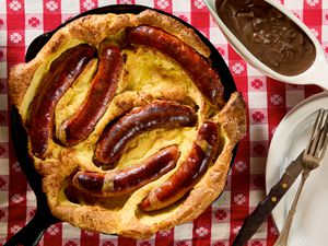 Toad in the Hole served in a skillet with a red checkered tablecloth