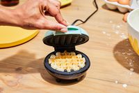 Person opening Dash Mini Waffle Maker
