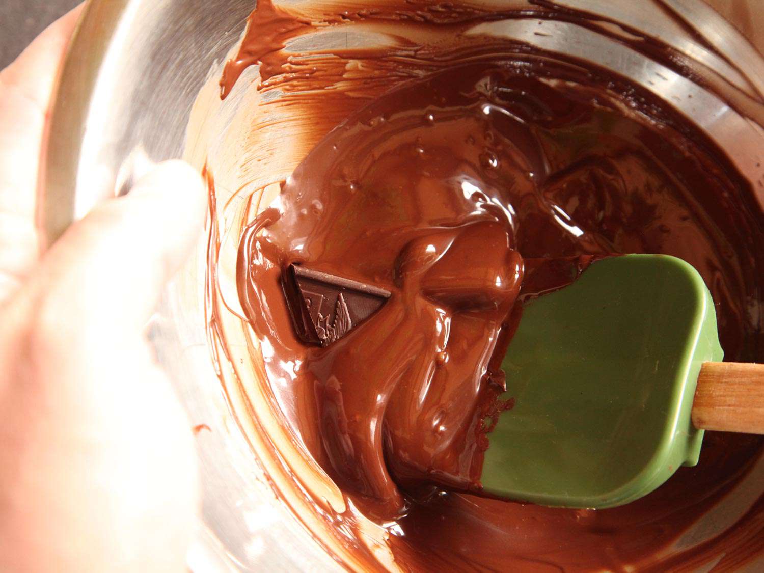 Combining chocolate with melted chocolate to temper the chocolate. 