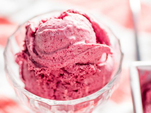 A small glass dish of homemade cherry ice cream.