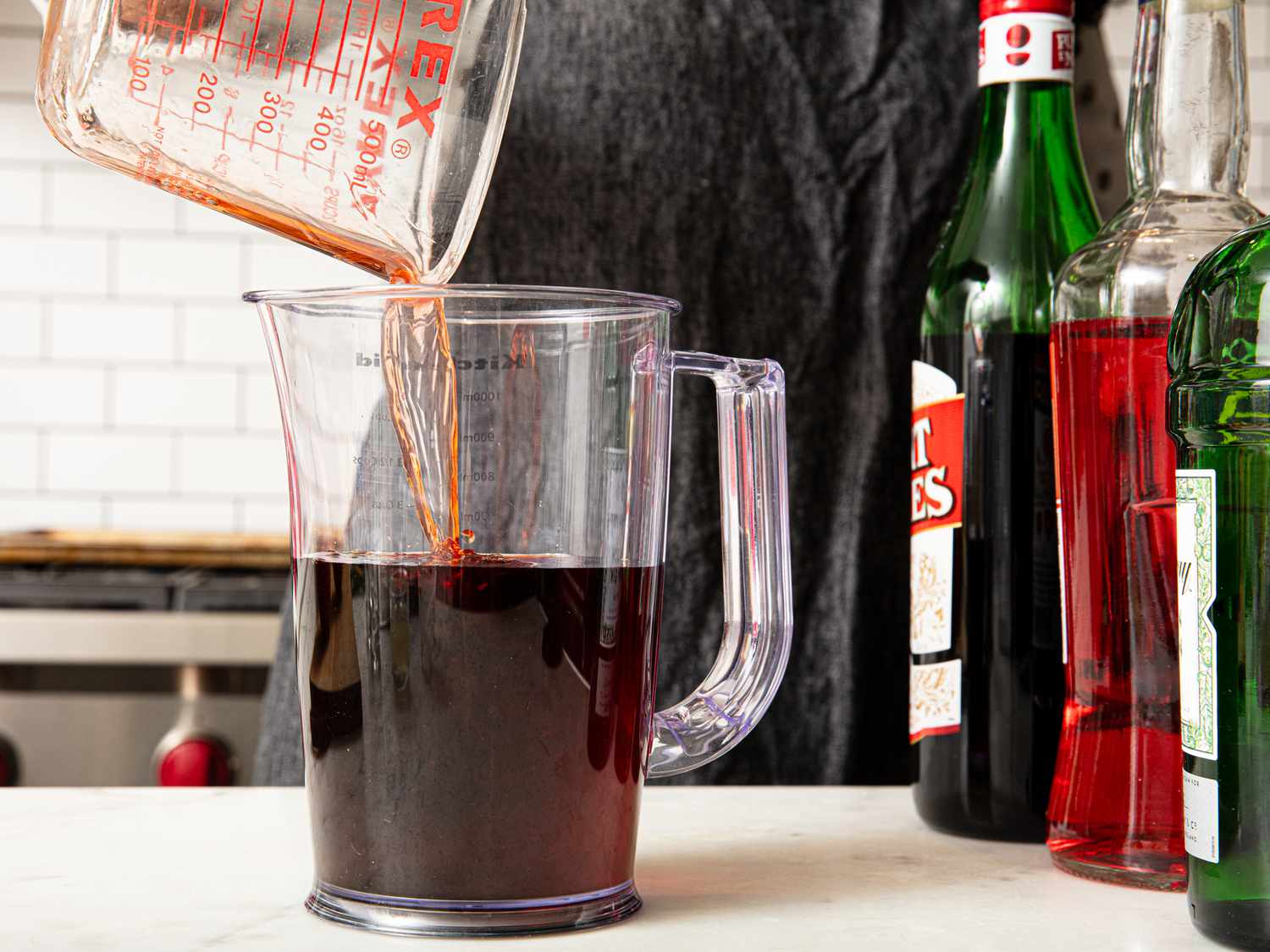 Pouring Aperol into pitcher