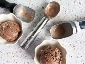 a few ice cream scoops with scoops of ice cream in bowls