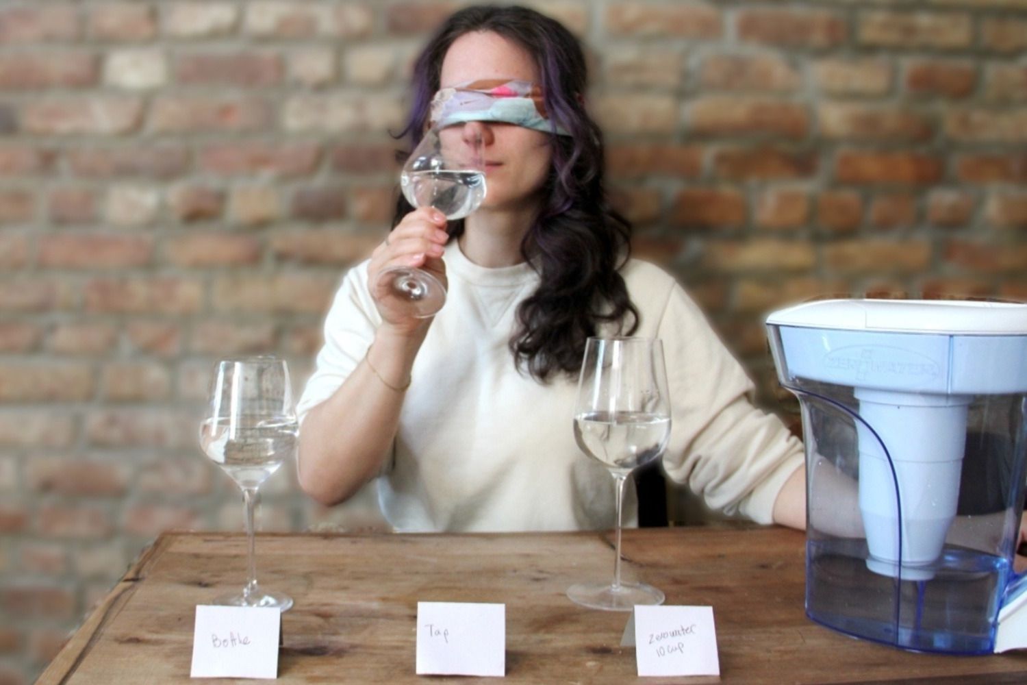 a person blind-tasting filtered water 