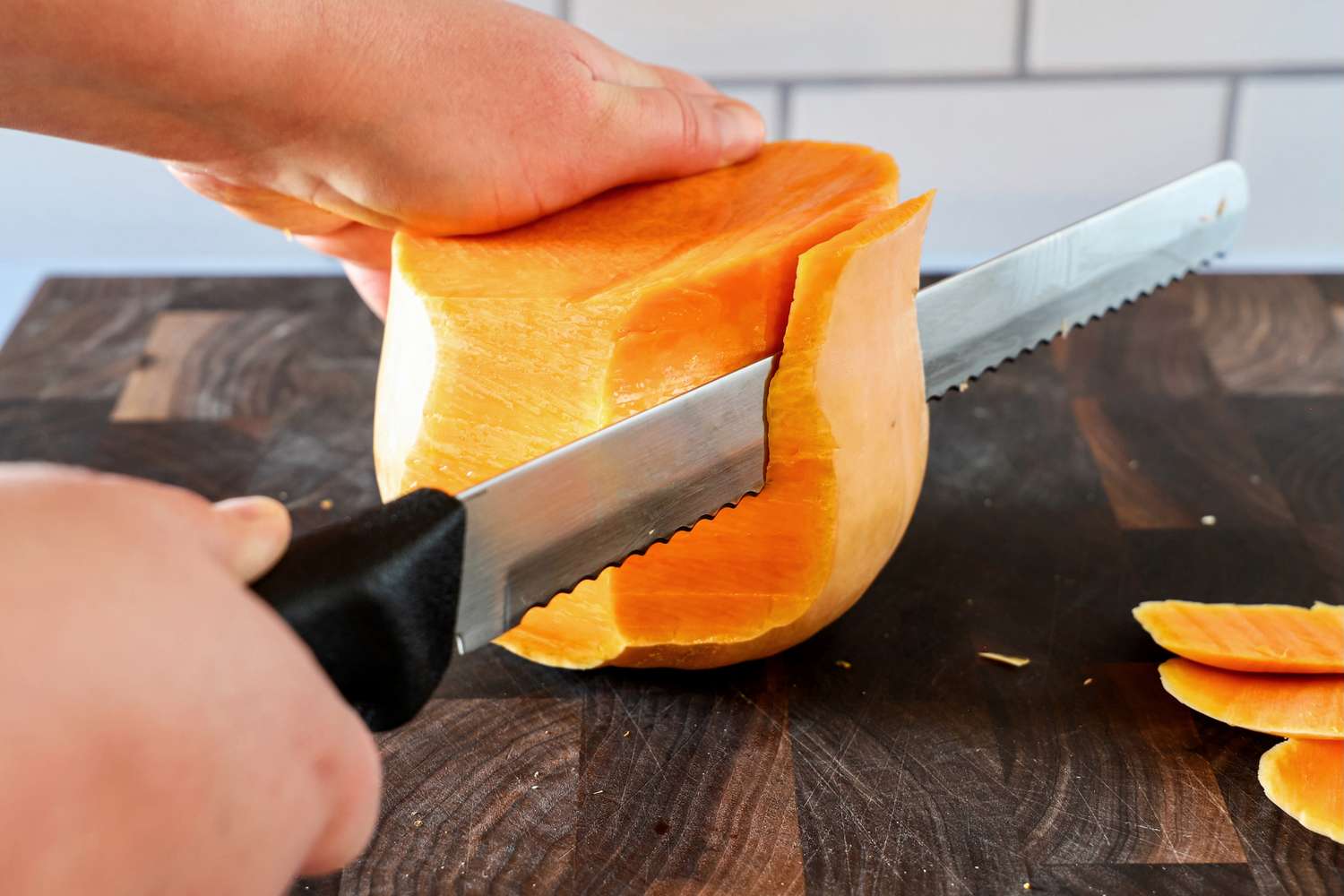 Person slicing with Dexter-Russell Basics 10-Inch Bread Knife With Black Polypropylene Handle