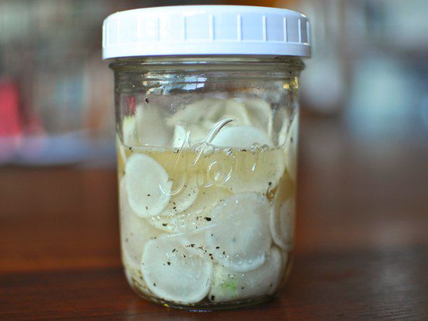 A pint jar of pickled hakurei turnips, ready to eat.