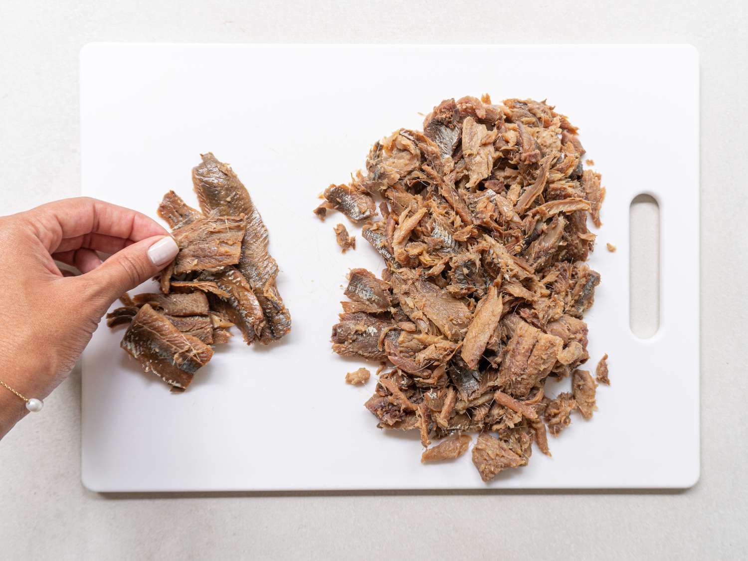 Overhead view of a hand picking fish