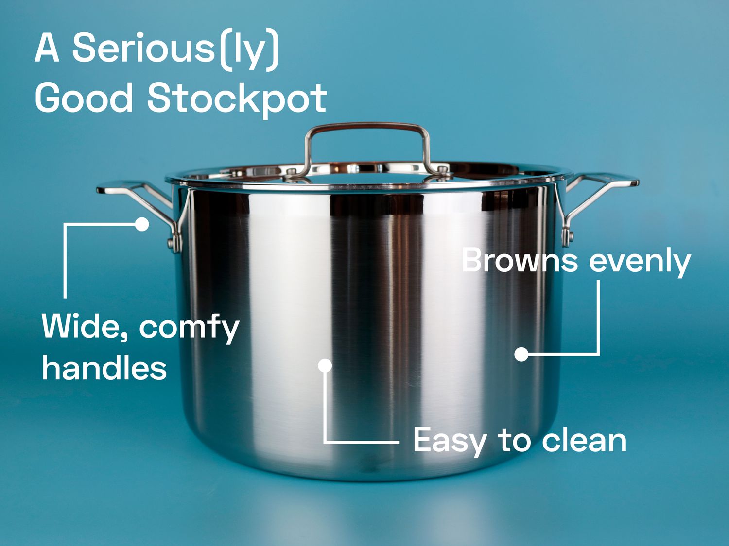 A stainless steel stockpot on a blue surface.