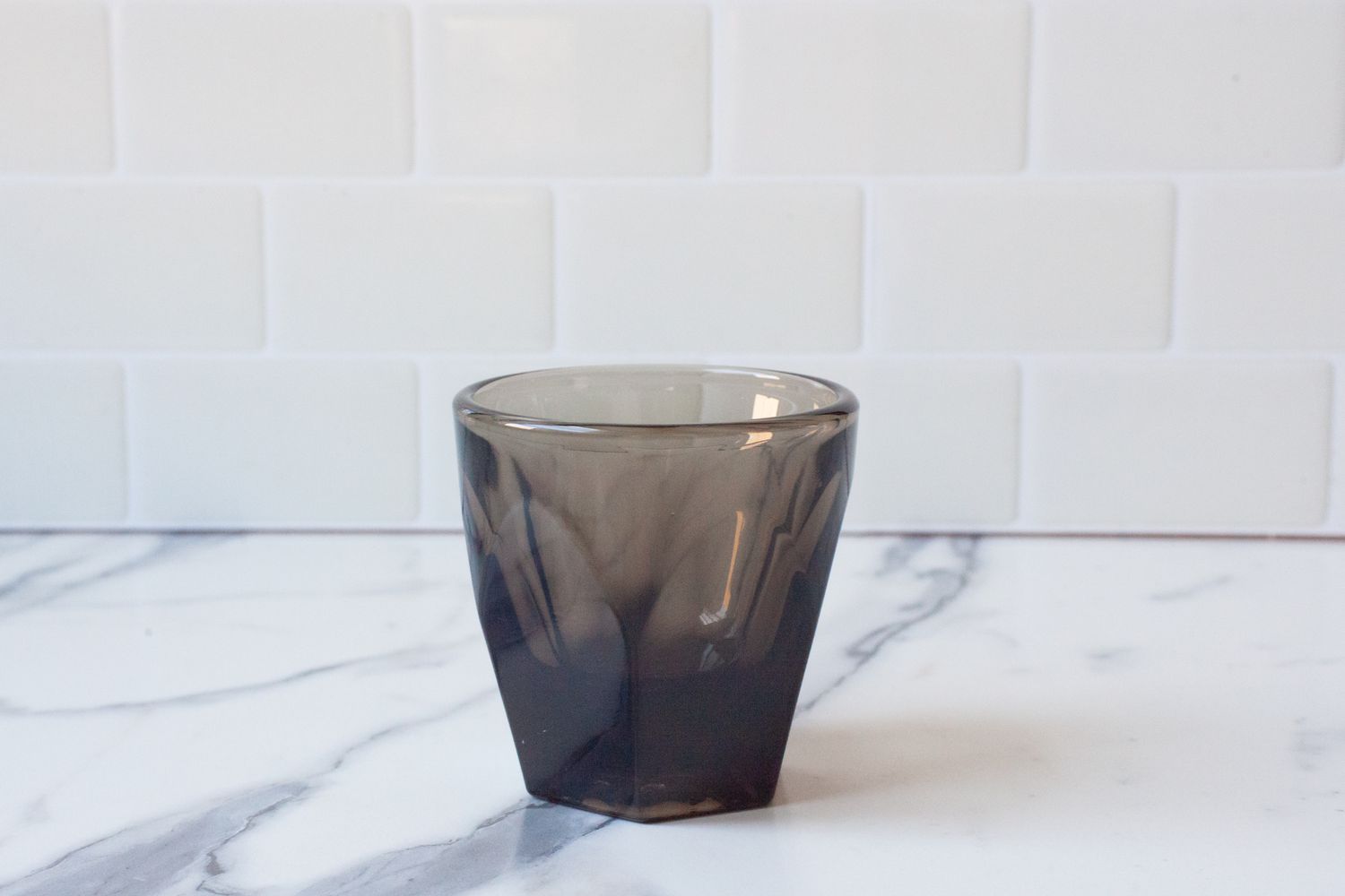 A grey Not Neutral espresso cup on a marble countertop.
