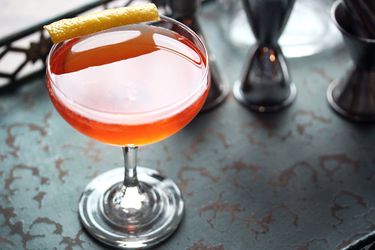 An Archangel cocktail, served in a coupe glass with a lemon twist.