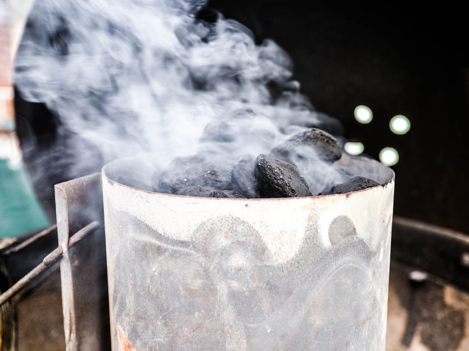 A chimney full of charcoal emitting smoke. 