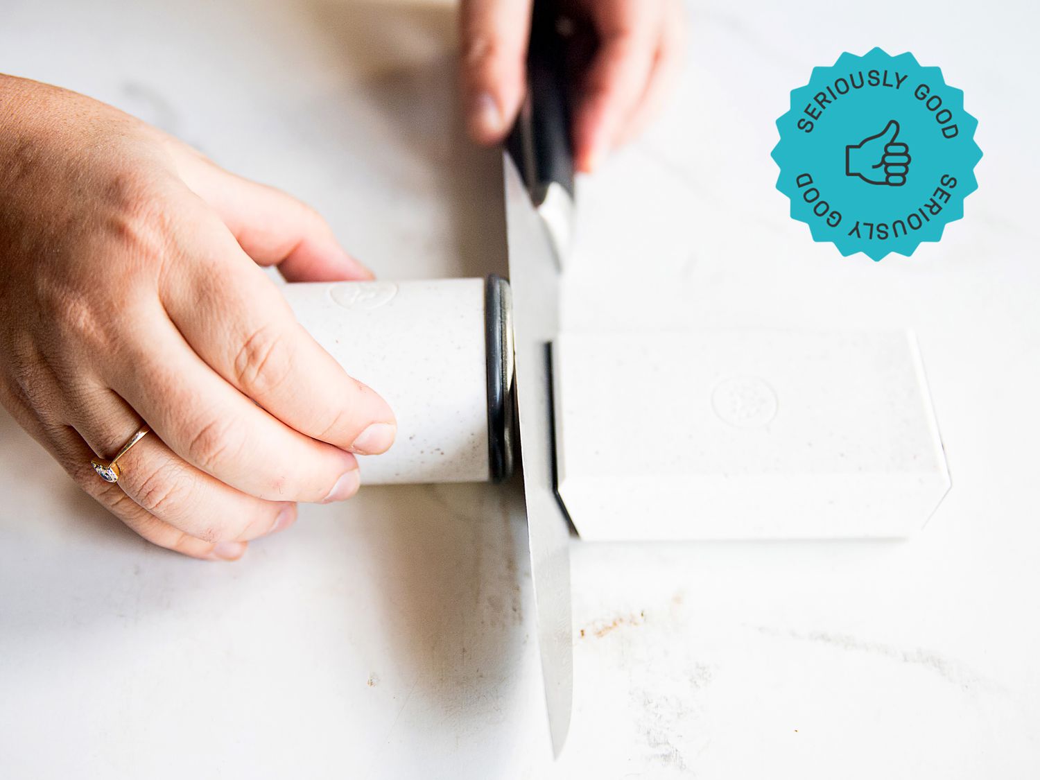 a person using the horl rolling knife sharpener to sharpen a chef's knife
