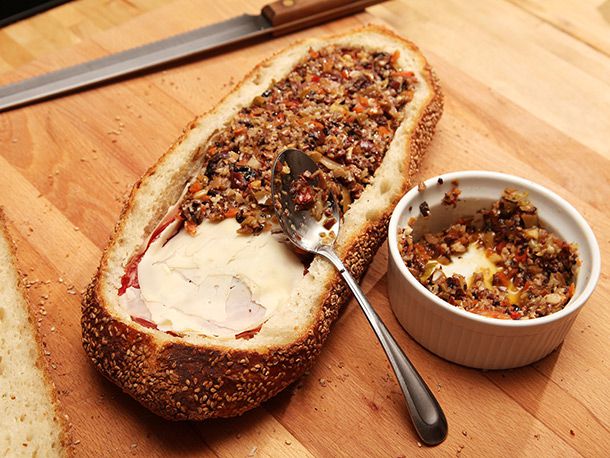 olive salad layered on top of sliced provolone