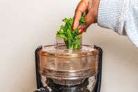 Kale being juiced in the Magic Bullet juicer