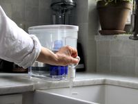 a person dispensing water from the Pur dispenser