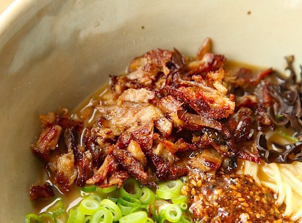 Crispy shredded pork resting in a ramen bowl.