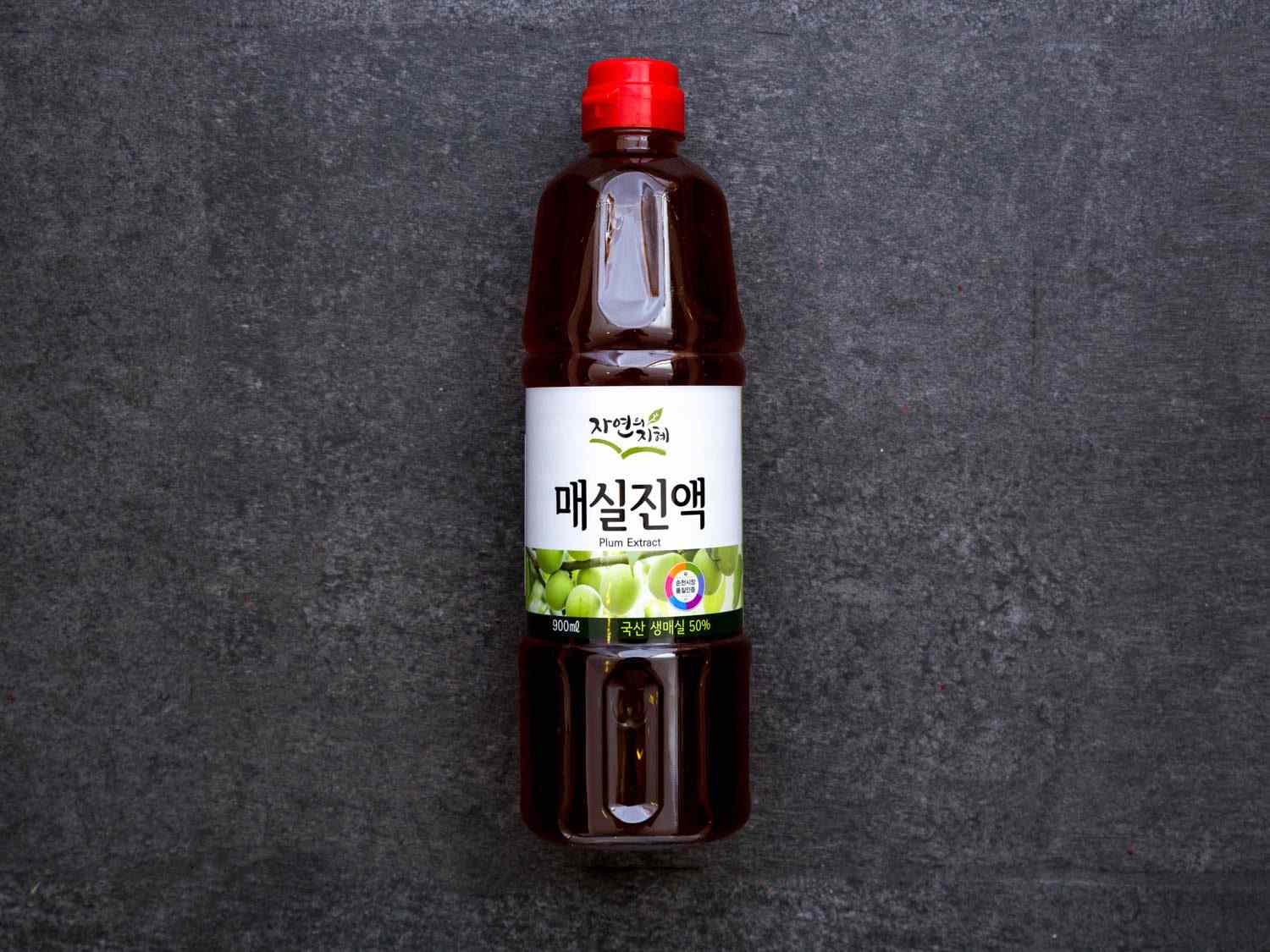 Closeup of a bottle of plum syrup.