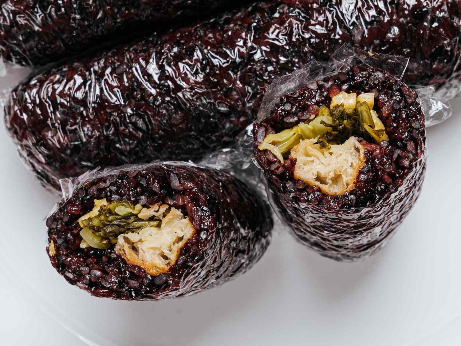 Overhead angle of sliced open Fan Taun rolls, inside filling visible 