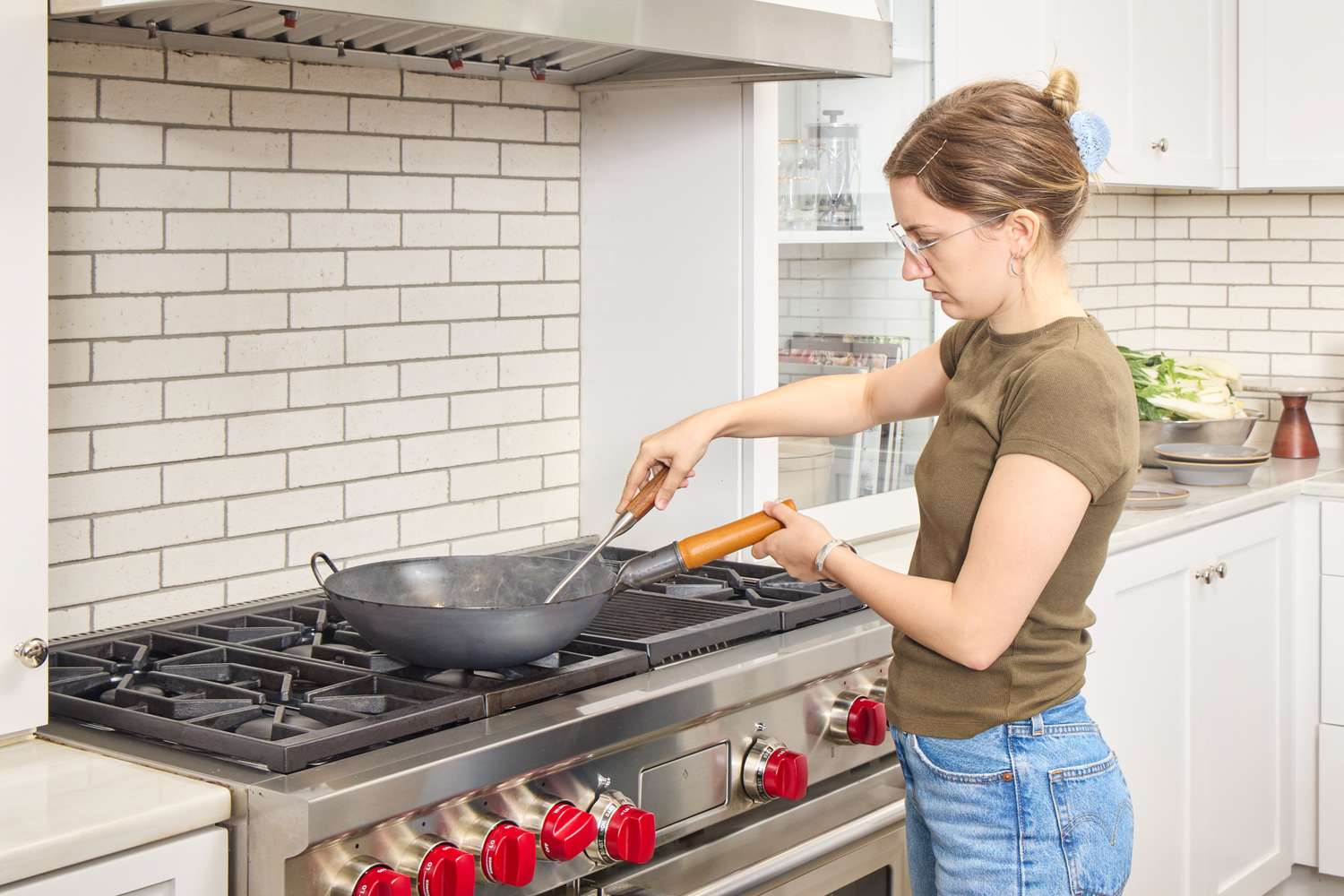 A person cooks food in the Yosukata Carbon Steel Wok Pan