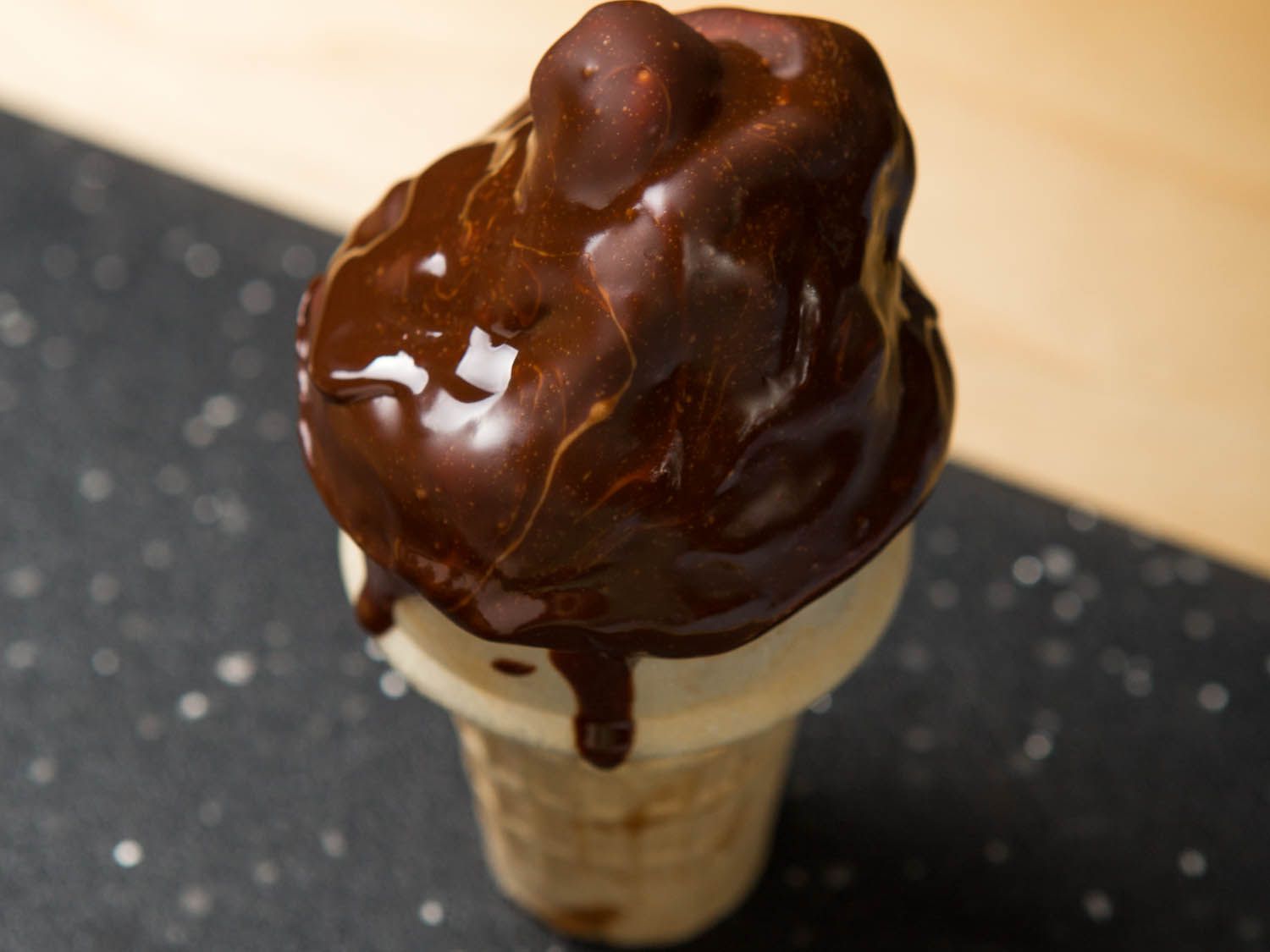Chocolate coating hardening on a soft-serve ice cream cone
