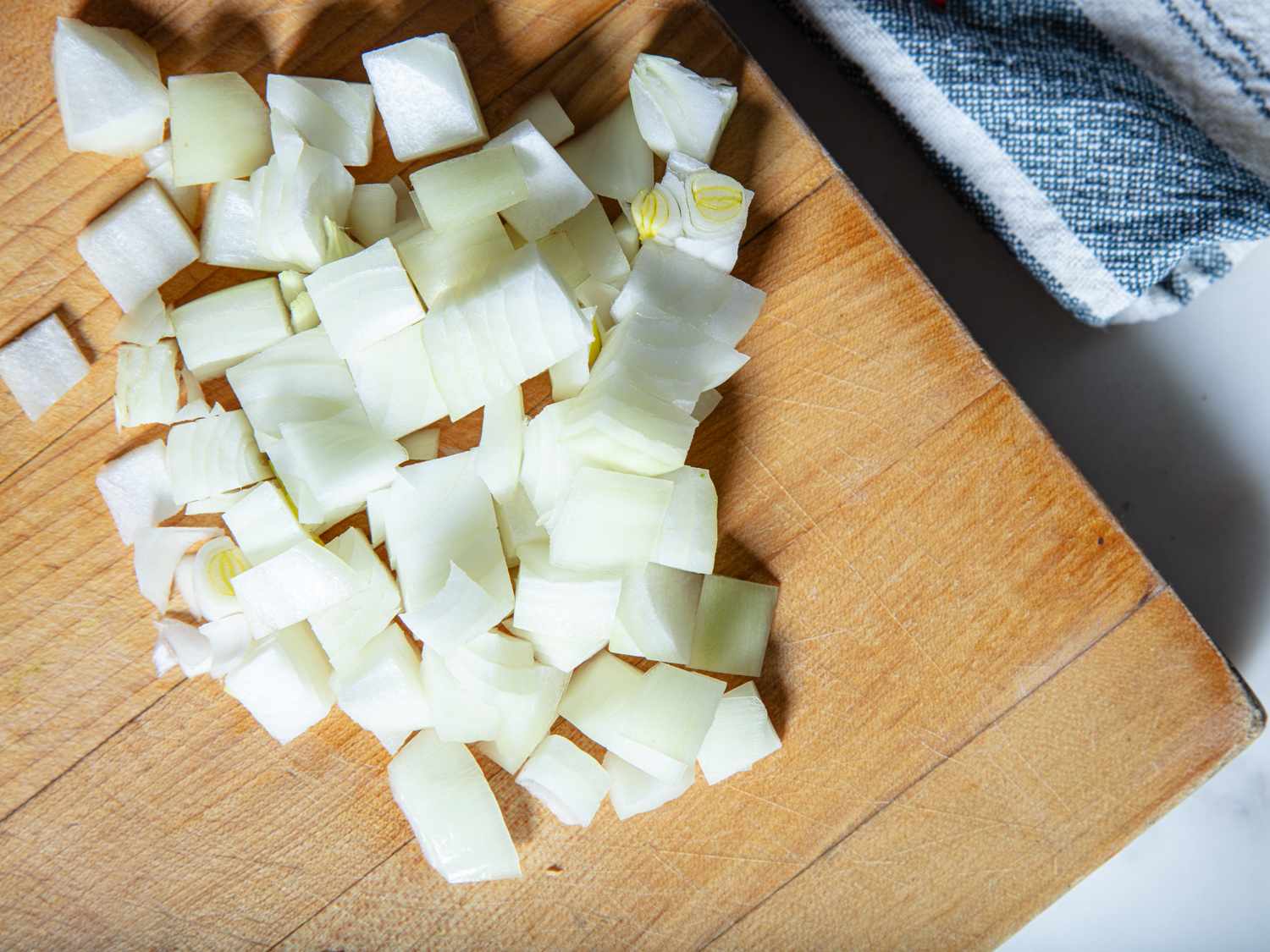 Diced onion on a cutting board.