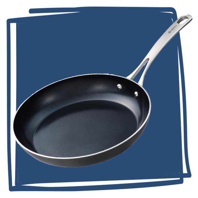 A nonstick frying pan with a stainless steel handle positioned in front of a solid background
