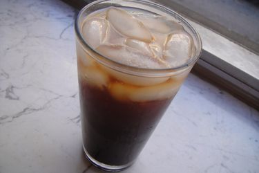 A glass of natural cola with ice. 