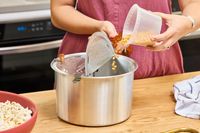 Popcorn kernels are poured into the Wabash Valley Farms Original Whirley-Pop Popcorn Popper