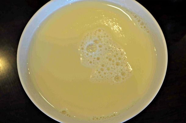 Closeup of hot soybean milk, served in a bowl.