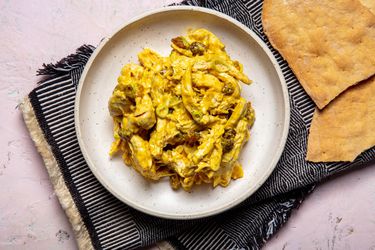 overhead shot of curry chicken salad on a beige plate