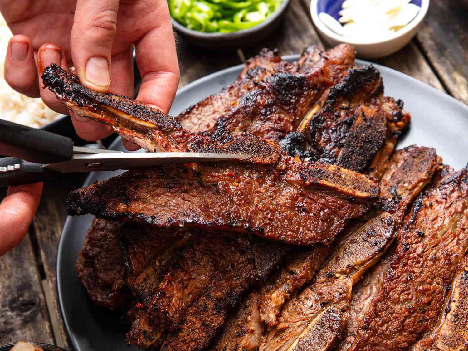 Cutting the boney portion off of a slab of beef galbi.